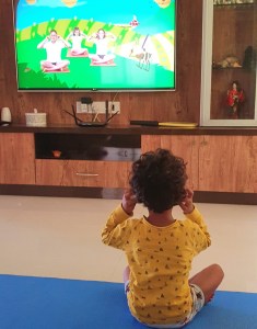 Child following yoga video online