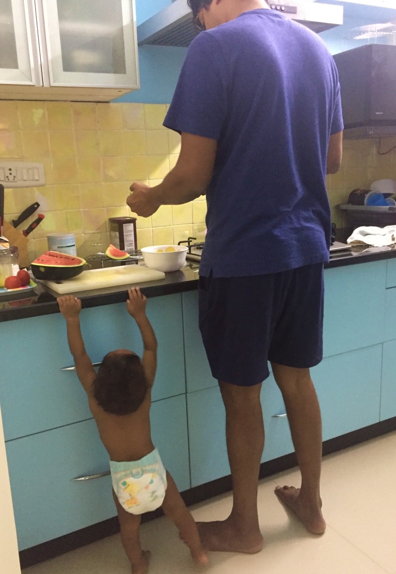 baby in diaper reaching to see