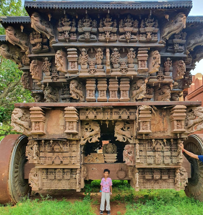 Elaborately carved large chariot with a child standing in front