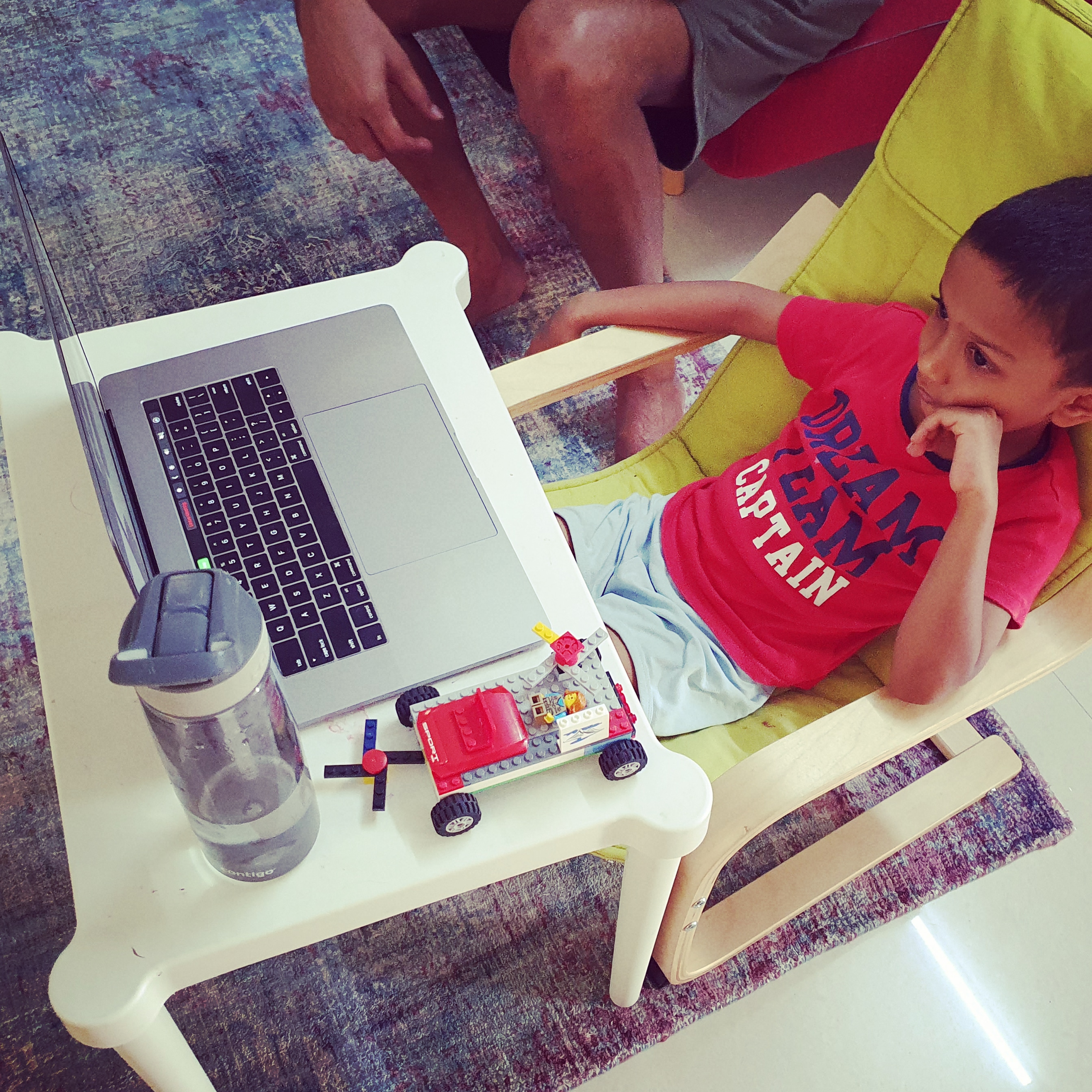 Child in front of a laptop attending online school
