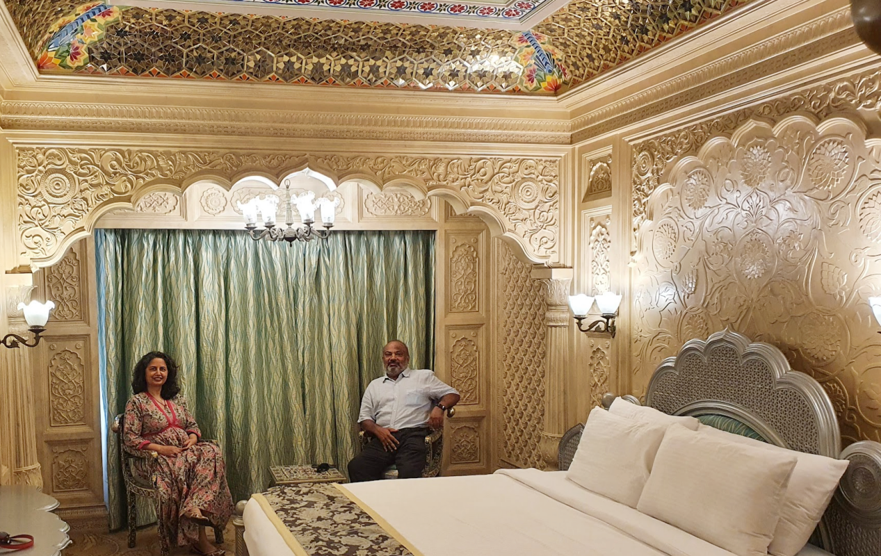 a couple sitting inside the elaborate mughal era themed room of hotel sitara at ramoji film city
