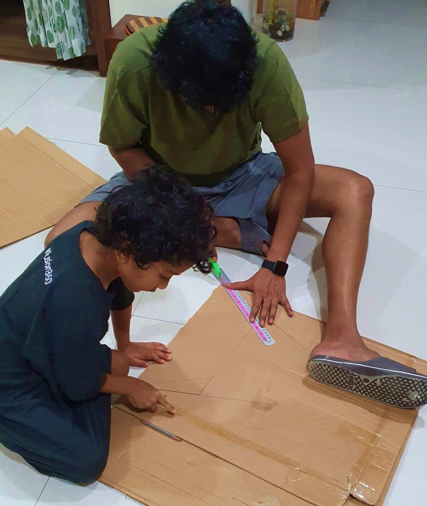 father and son making a DIY christmas tree