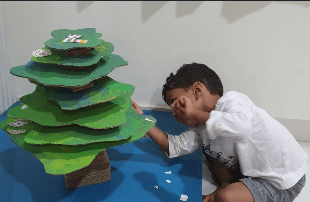 Child decorating a DIY christmas tree