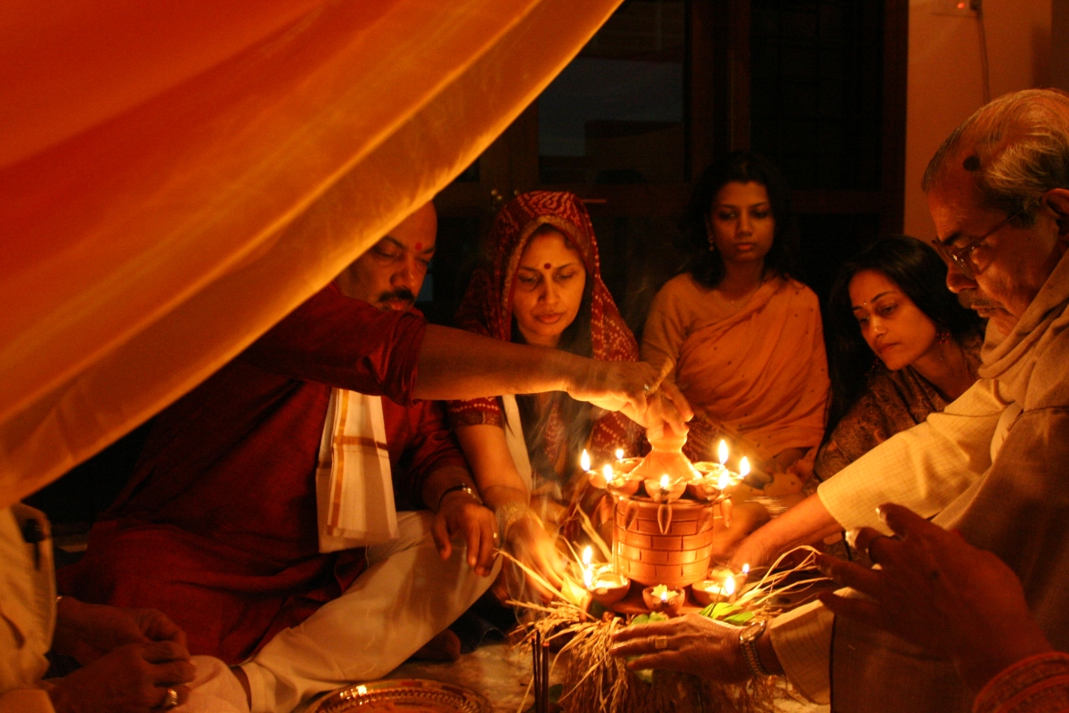bride with parents and relatives performing a worshipping ceremony