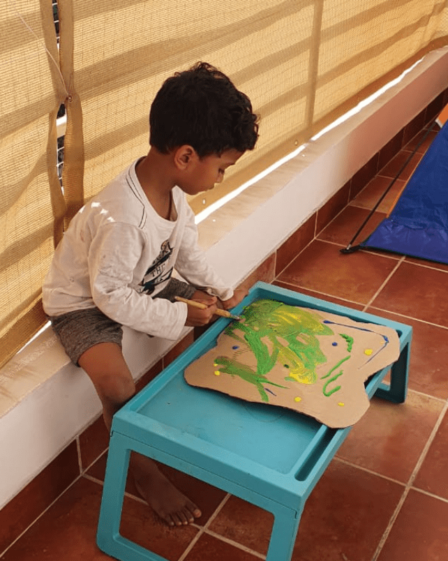 child painting a diy christmas tree
