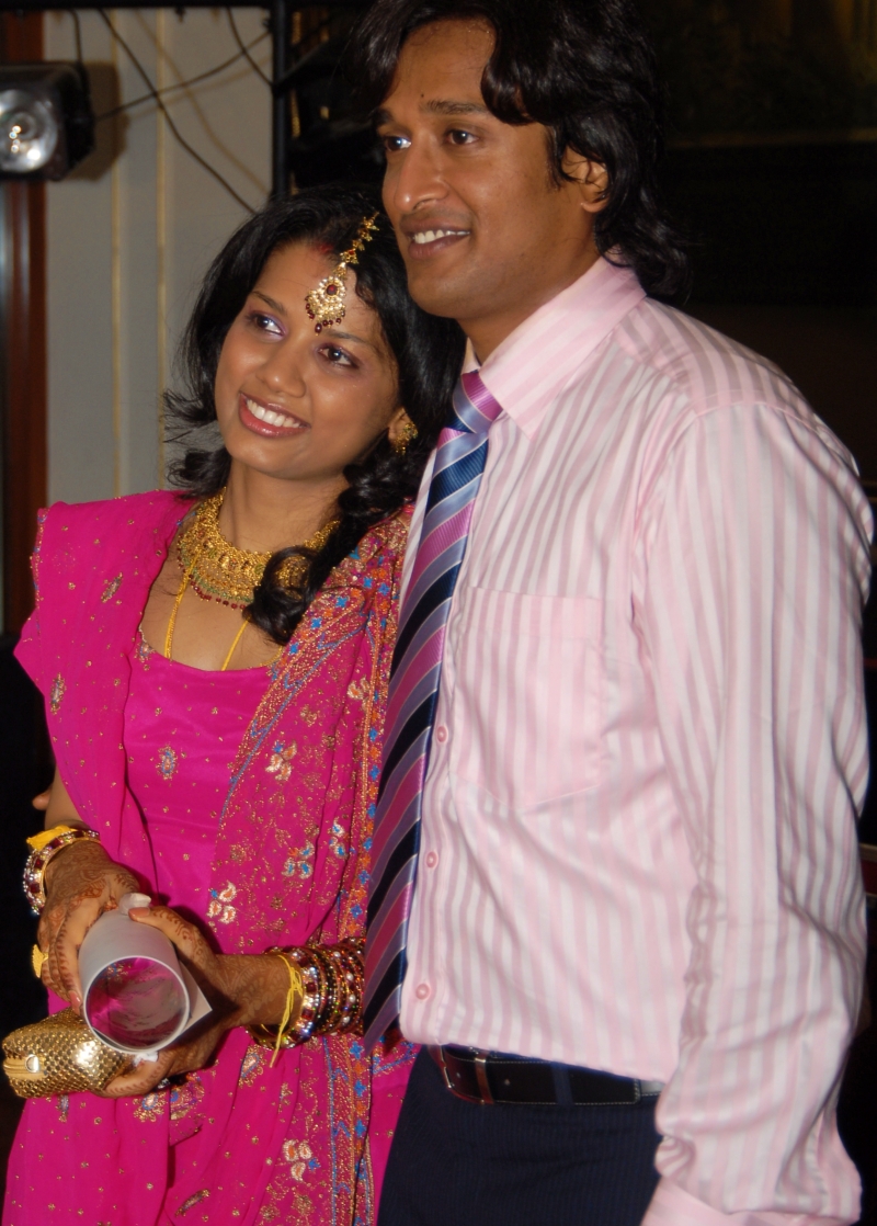 bride and groom in pink for the wedding reception
