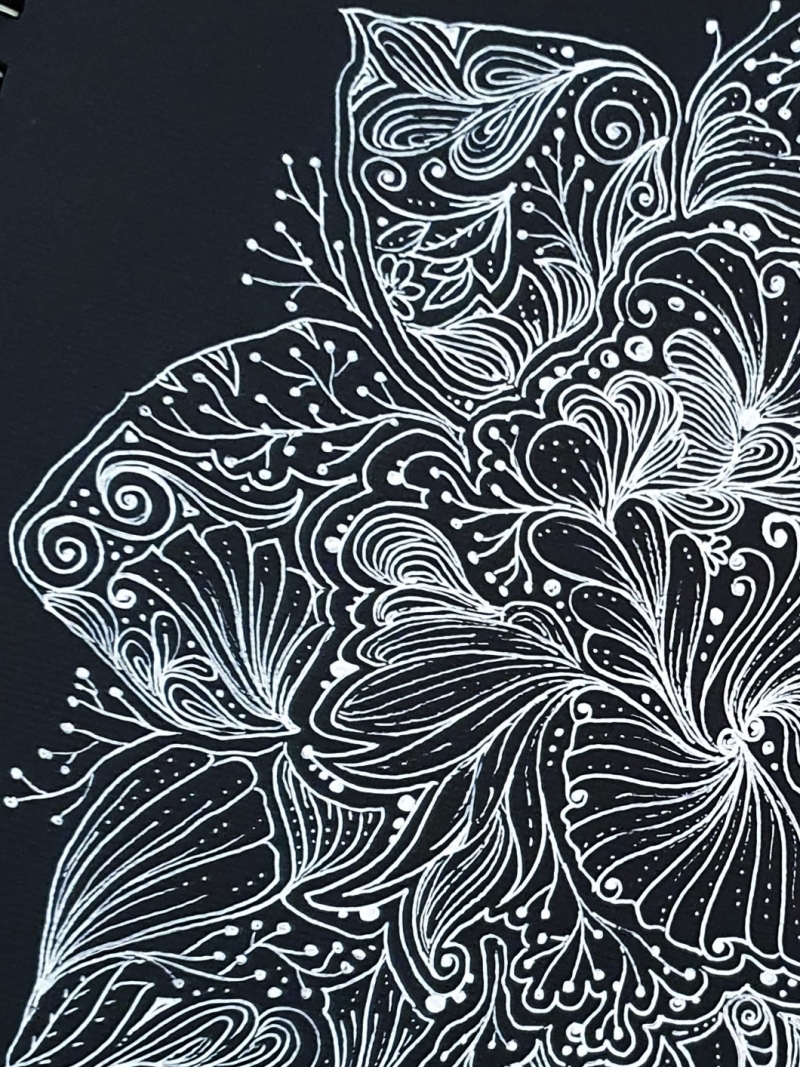 striking white gel pen doodle art on black paper