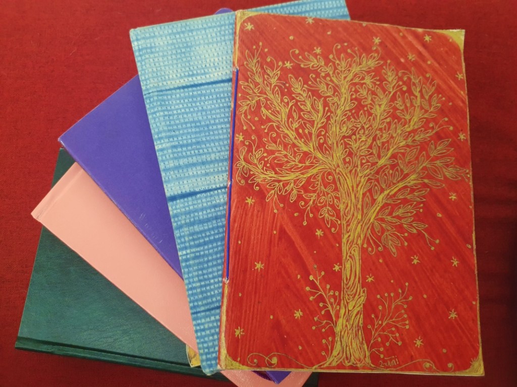 a pile of art journals