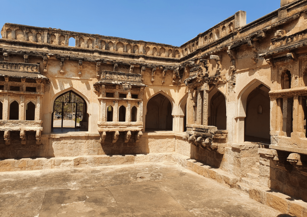 Hampi Queen's Bath complex from inside with ornate carved window sit outs