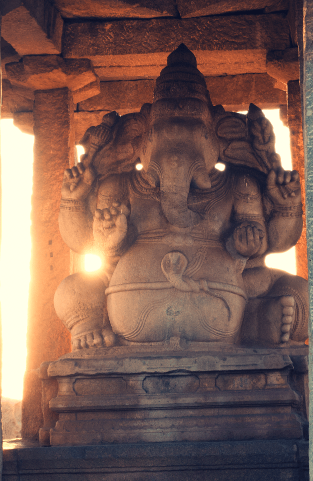 Hampi Sasivekaalu Ganesha statue with the sun setting behind it
