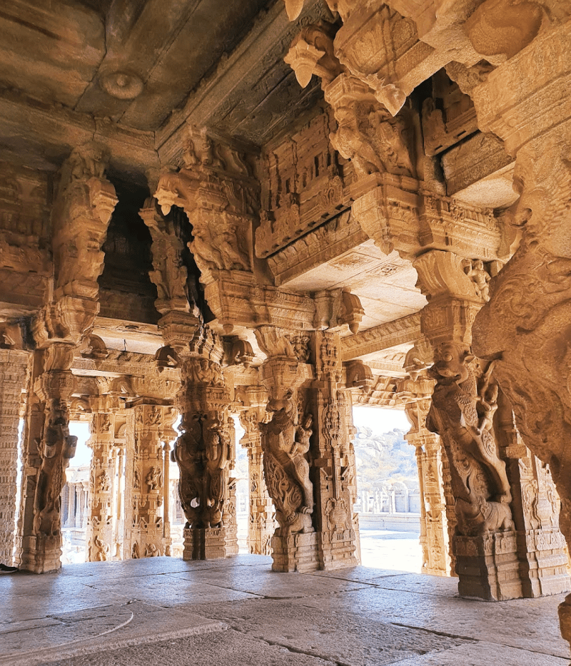 Hampi Vijaya Vittala temple pillars carved with many images of gods and animals