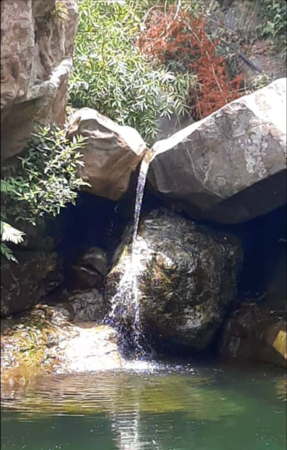 small gentle waterfall between boulders