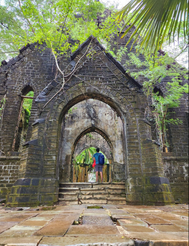 The ruins of an old church entrance at Ross Island now overtaken by moss and greenery