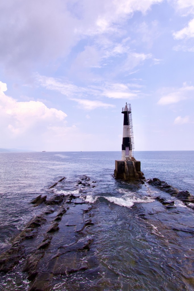 a small lighthouse in the open sea