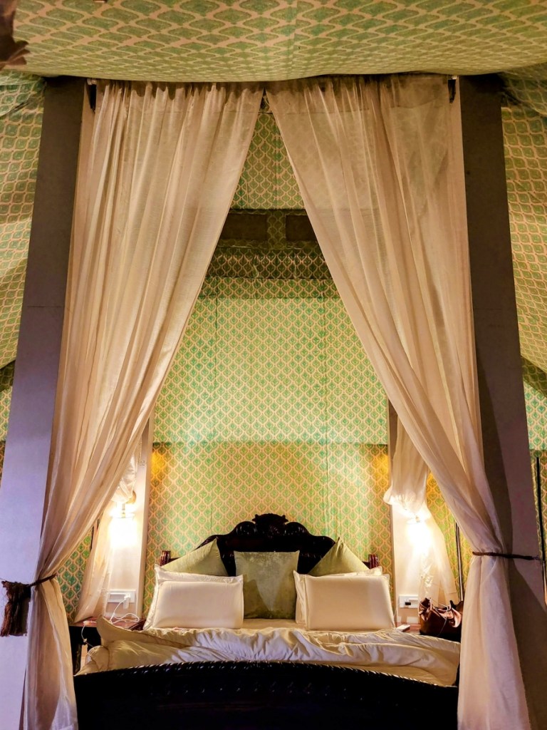 bed with curtains on the sides inside the luxury tent