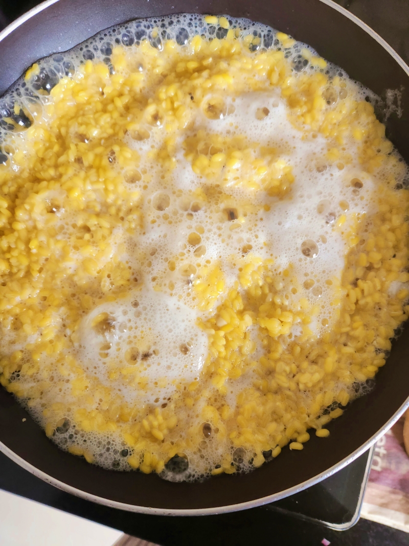 yellow moong dal cooking in a saucepan
