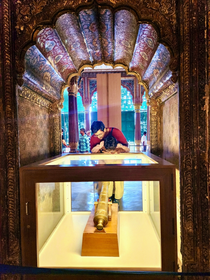 man and child looking at a small canon on display at Daria Daulat Bagh