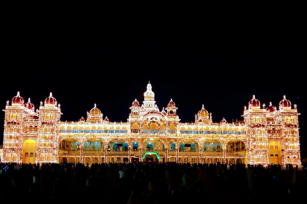 the mysore palace all lit up against a black sy