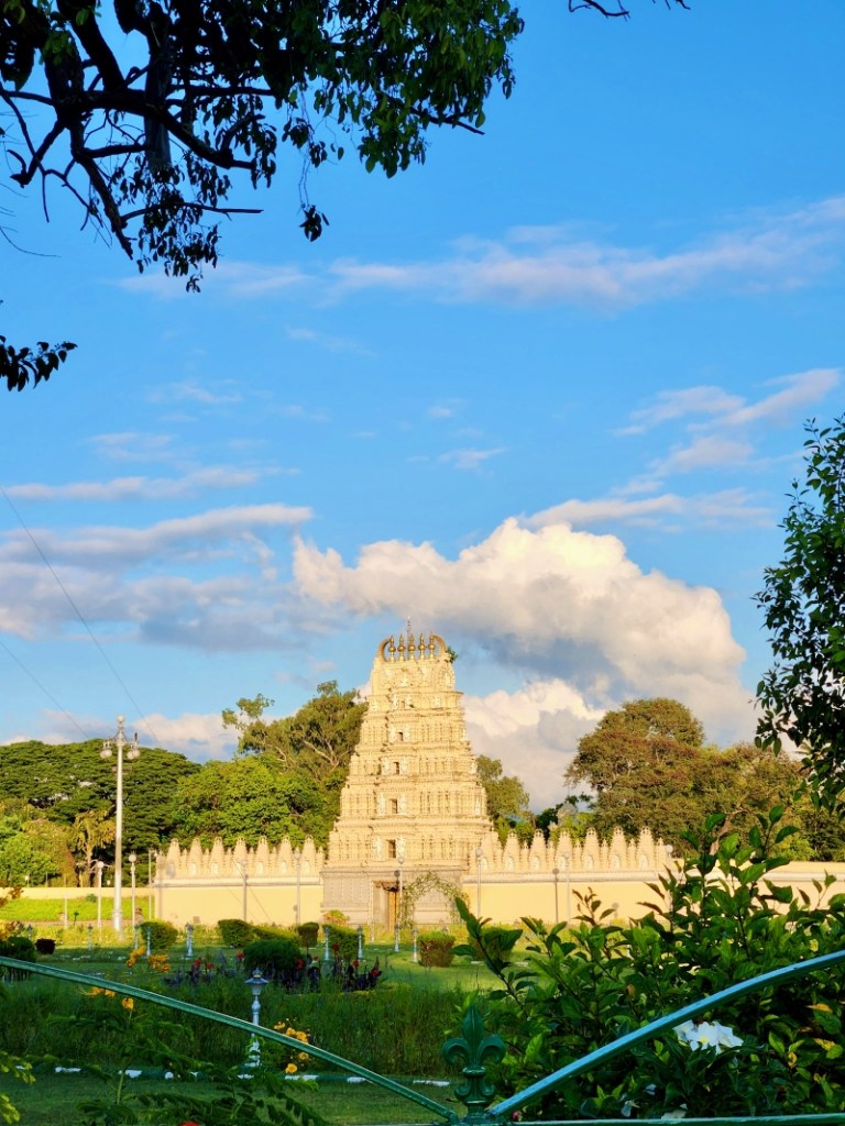 Bhuvaneshwari temple with it's white tower glistening in the morning sun with blue skies and a garden in the front