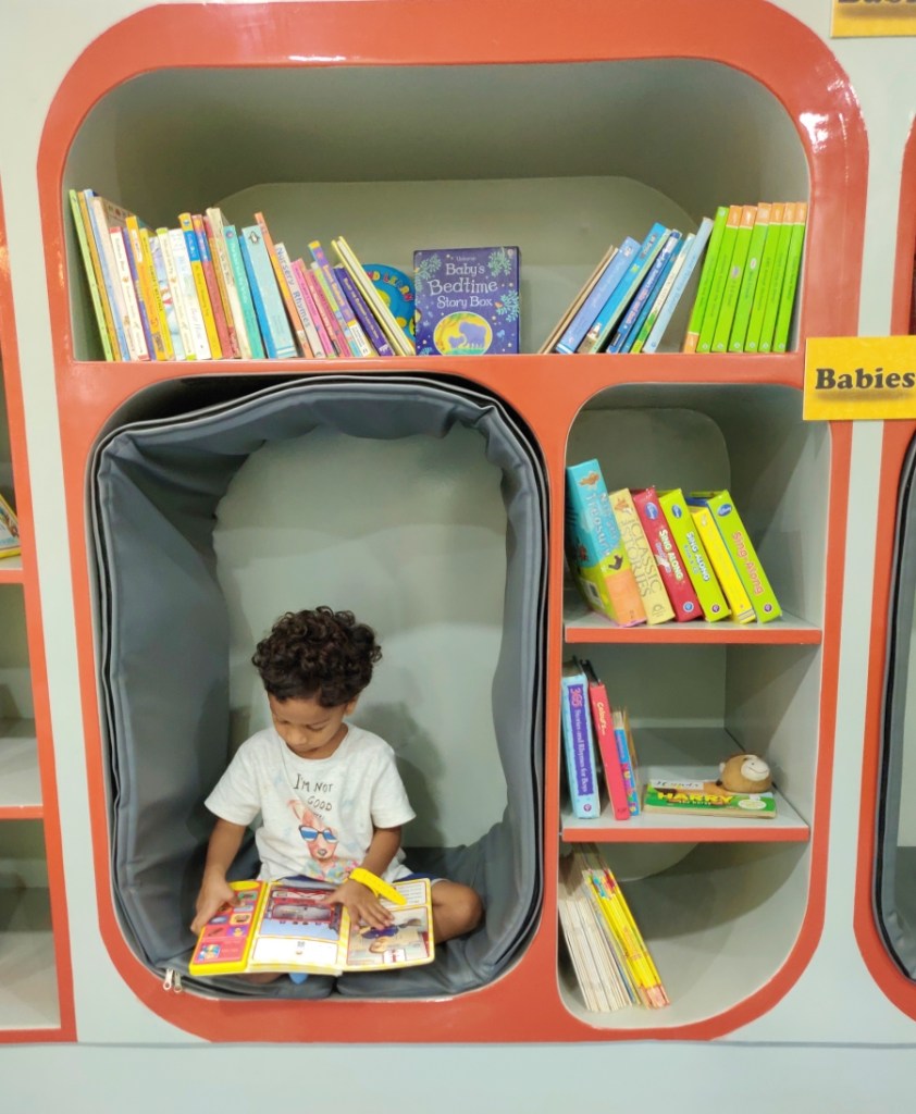 Child in a reading nook reading a book