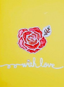 a red rose on yellow background and captioned