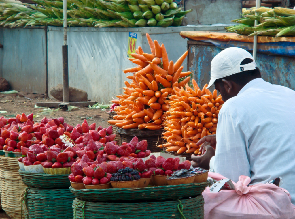 Vendor selling Mahabaleshwar strawberries and carrots