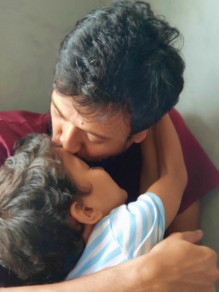 father and son kisses