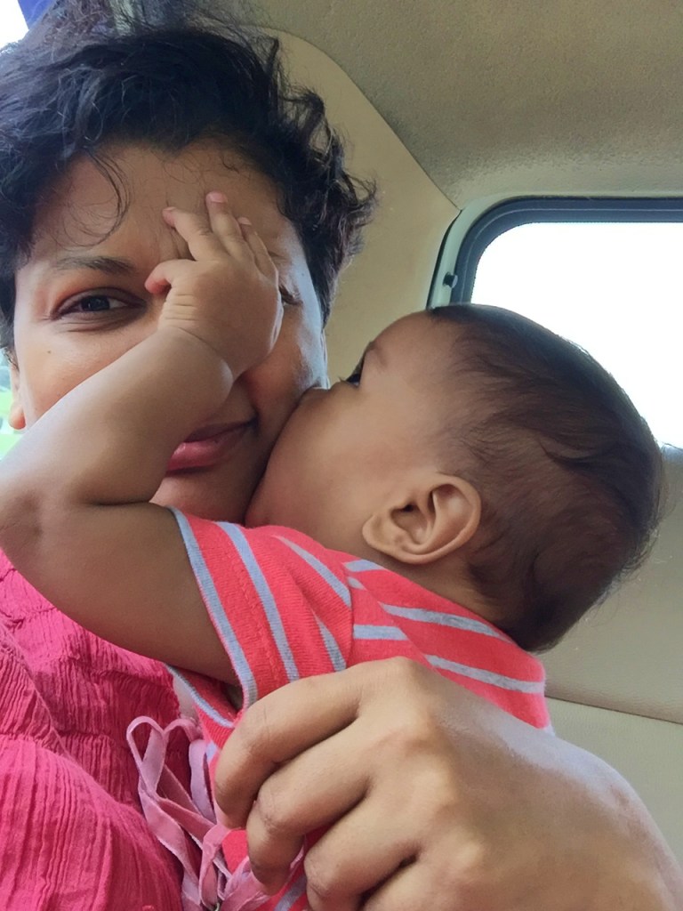 mom and baby kisses in the sunlight