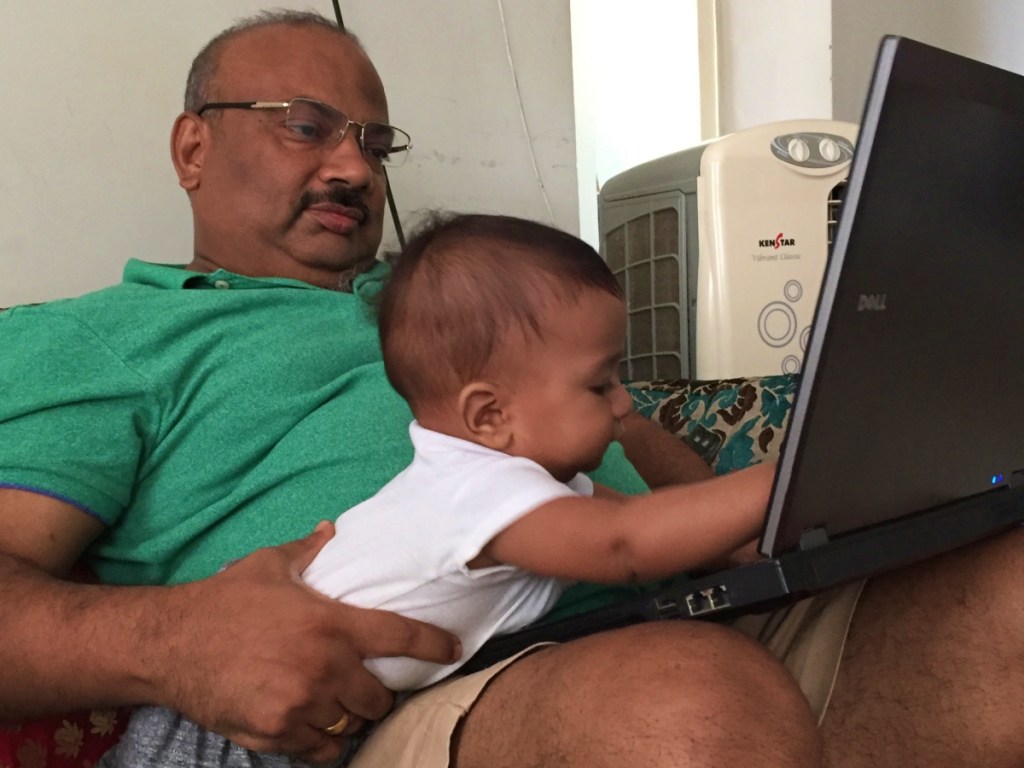 grandpa with baby playing on the laptop